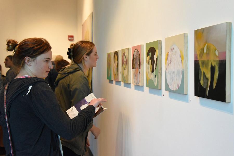 Santa Barbara City College students Cayla Eggemyer, front, and Rebekah Bradbury take in the art on Friday, Feb. 27, 2015 at the Atkinson Gallery “Missing Rib” exhibition by Maria Rendon in Santa Barbara, Calif. Bradury remarked that the exhibition had “Really high quality art for a college gallery.