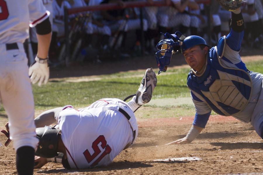 Oxnard College catcher Daniel Barnett (No.12) tags out City College catcher James Hill (No. 15) at home plate in the second inning Thursday, March 26, at Pershing Park. The Vaqueros lost to Oxnard College, 4-2.