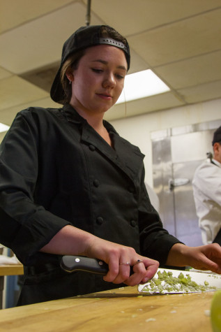 Culinary Arts student Madeline Dyer dices celery for risotto to be served in the John Dunn Gourmet Dining Room, Thursday, March 19, 2015, in the City College Campus Center in Santa Barbara, Calif. Dyer is in her fourth semester of the program, where students are in charge of all preparations for the Gourmet Dining Room dinners.