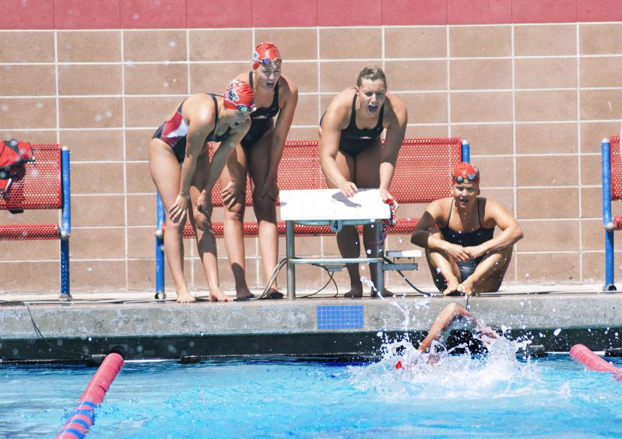 City College swimmer, Sarah Westmorelan, swims as anchor in the 4x100 yard freestyle relay while teammates (from left), Elise Hazel, Madelyn Brooks, Autumn Lovett and Katherine Moose Warren cheer for her on Saturday, March 28, 2015, at San Marcos High School in Goleta, Calif. City College placed first in this race with a final time of 4:02.69.
