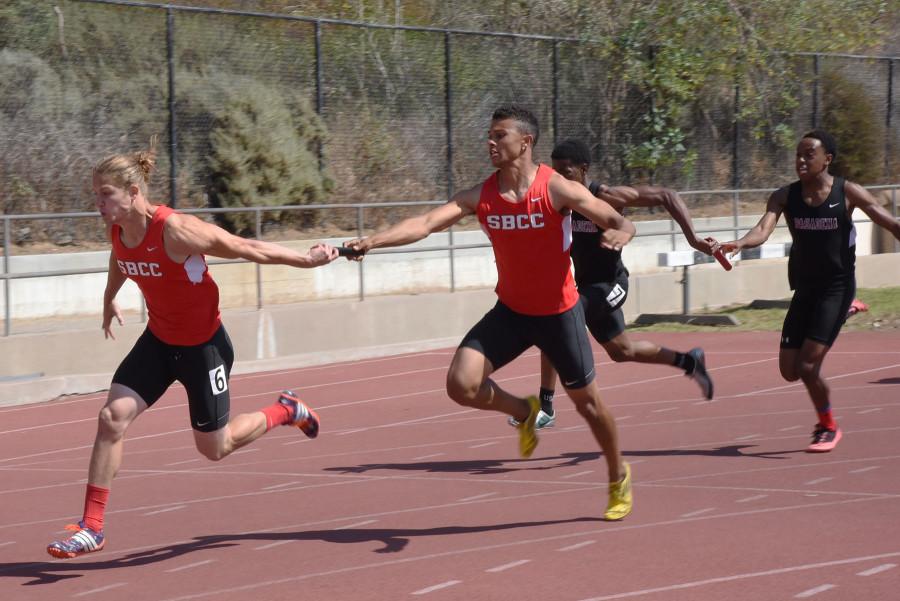 Tyler Higby receives the baton from Simon Bailey during the 4X100 meter relay event during the Santa Barbara Easter Relays at La Playa Stadium on Friday, March 20, 2015, in Santa Barbara Calif. The men won the 4X100 meter relay with a time of 42.18 seconds.