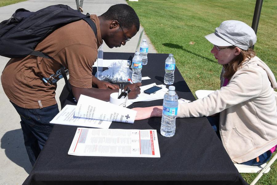 Radiology major Ricky Yarder, 23, signs up to join the Red Cross Club by its President Paulina Fisher, Wednesday, March 19, on City College’s West Campus in Santa Barbara. The Red Cross Club was formed in Fall 2014 and is looking to be more active in the community.