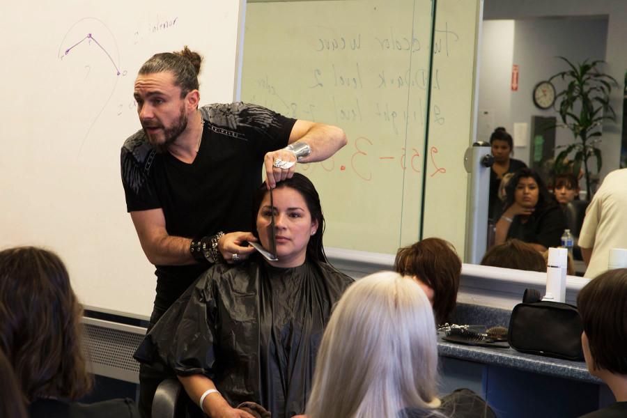 Raphael Perrier, a prominent hair stylist, demonstrates his hair cutting techniques on model Margarita Perez, a student in the cosmetology program, Tuesday, April 21, at the Cosmetology Academy in the Magnolia Shopping Center in Goleta. The most important part of a haircut is all the geometrics, says Perrier.