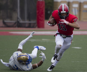 Elijah Cunningham #13 pushes past Hancock defensive back after a reception Saturday Sept. 12, 2015 at La Playa Stadium in Santa Barbara. City College beat Hancock 21-20.