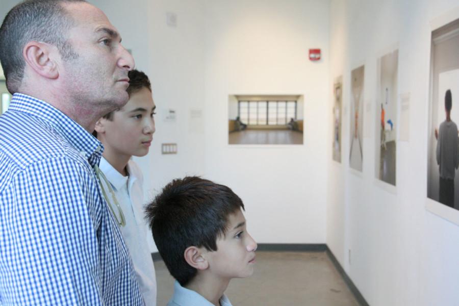 Doug Kottler (left), a former student of artist Richard Ross, is joined by sons Miles and Nathan, as they observe Ross’s photographs on display at the ‘Isolation’ exhibit opening on Friday, Sept. 25, at the City College Atkinson Gallery, Santa Barbara.