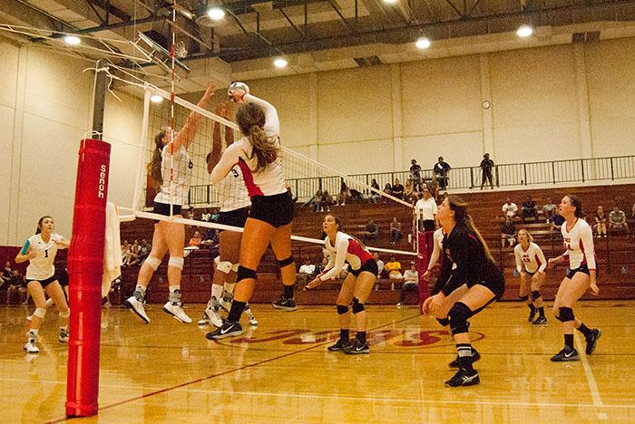 Santa Barbara City College outside hitter Katelynn Womack (No. 18) gets the ball past College of the Canyons blockers to score a point in the fourth match, 17-18, on Wednesday night, Sept. 30 in the Sports Pavilion in Santa Barbara. The Vaqueros beat the Cougars, 3-1.