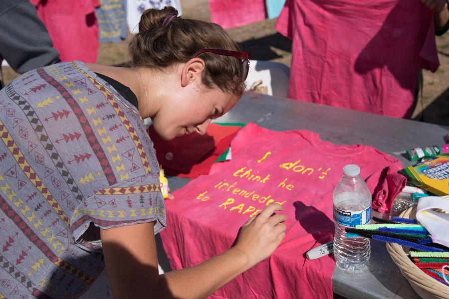 Rachel Bourke, city college student and feminist club member, puts the finishing touches on a t-shirt for the SBCC 2015 Clothesline Project, Monday morning, Oct. 26, in the Friendship Plaza on East Campus. The Clothesline Project is an effort to raise awareness about sexual violence and is presented by Student Health and Wellness and City College Connect, with participation from the Feminist Club, the Rape Crisis Center, the Health and Wellness Center and the Pacific Pride Foundation.