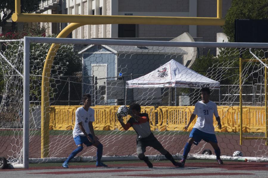 Santa Monica College goalkeeper Weston Adkins (No. 1) intercepts soccer ball while teammates, midfielder Saul Medina (No. 2) and defender Richard Perez (No. 21) look on, at 2 p.m. Friday, Oct. 9 at La Playa Stadium. The game ended in a 1-1 tie.