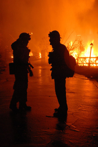 Two Los Angeles City Firefighters discuss tactics on how to save structures on Camino Alto just after midnight on Friday, Nov. 14, 2008, in Santa Barbara. 10 college students, nine of them from City College, started the Tea Fire.