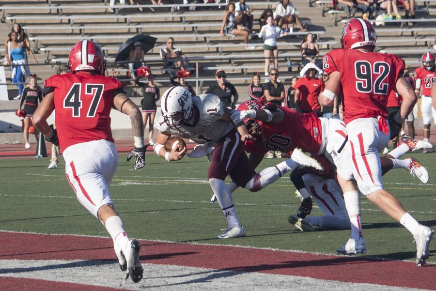 Antelope+Valley+quarterback+Blake+Shepherd%2C+%28No.+1%29%2C+crosses+into+the+end+zone+to+score+past+City+College+defensive+lineman+Lordes+Jones%2C+%28No.+90%29+tying+the+game+at+38-38+at+1+p.m.+Saturday%2C+Oct.+31%2C+at+La+Playa+Stadium.+City+College+later+won+the+game+in+ovetime+41-38.