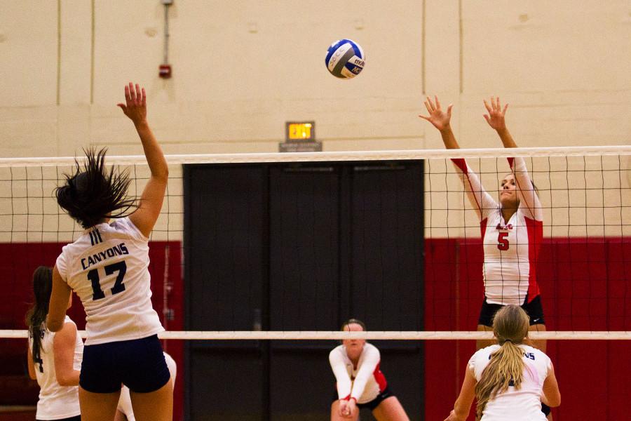 Middle blocker Isabella Thompson (No. 5) misses the ball from College of the Canyons player Emily Bible (No. 17) near the end of the fourth set, Tuesday, Dec. 1, in the Sports Pavilion at Santa Barbara City College. The Cougars beat the Vaqueros, 3-1.