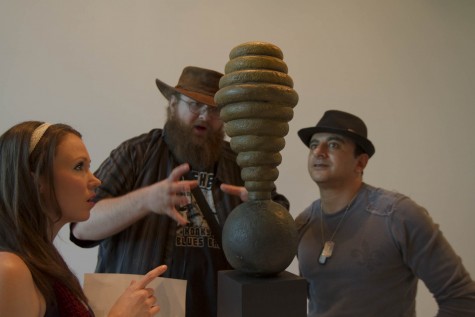 From left, Briar Bates, Michael Lee, and Sami Ibiahin interpret the Hive Sculpture on Friday, Jan. 29, at the Atkinson Gallery art exhibition Ed Inks Has Left the Building. All the sculptures were for sale at the reception by retiring City College artist Edward Inks.