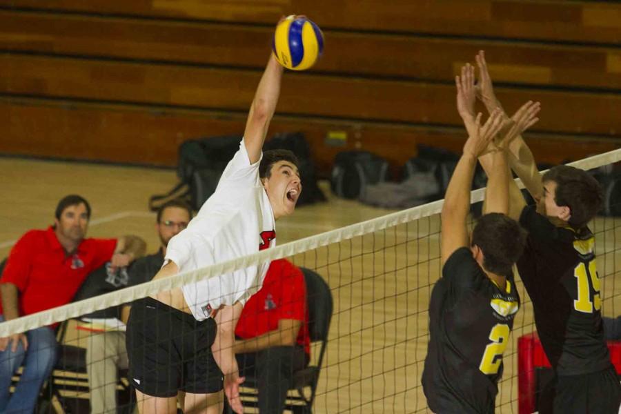 Taylor McCluskey (No. 4) Spikes the ball over the net Wednesday night, Feb. 24, in the Sports Pavilion. McCluskey had 14 kills and 10 digs by the end of the game.