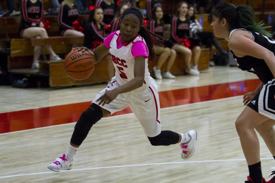 Christina Mattis (No. 5) passes Stephanie Gurrolla to make a field goal within the three point line scoring 2 out of the 9 points that she scored late Saturday afternoon, Feb. 20, at the Sports Pavilion. City College beat La Pierce, 58-53