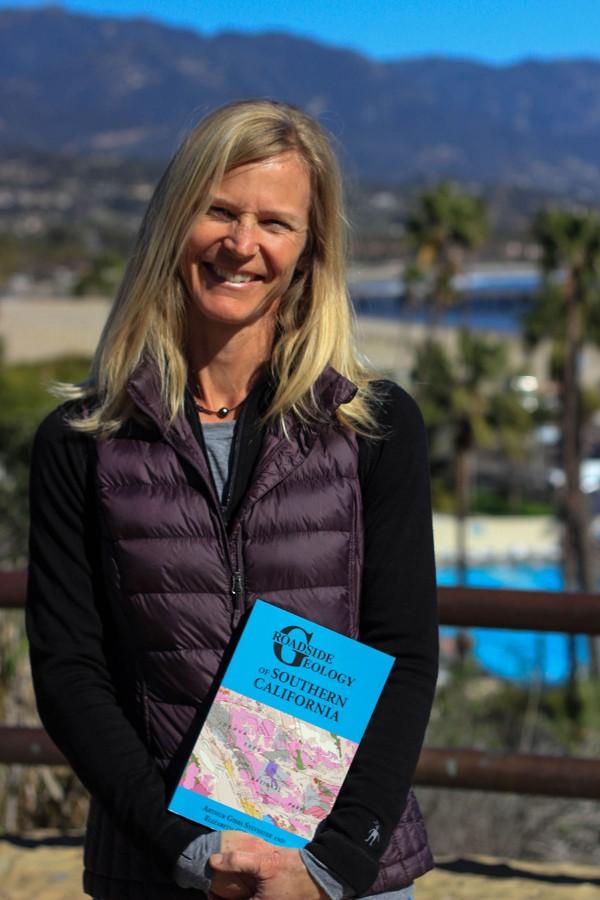 Elizabeth Gans, geology lab assistant at Santa Barbara City College, with her newly published book “Roadside Geology of Southern California” on Thursday, Feb. 4 at the Winslow Maxwell Overlook on East Campus. The book is a motorist’s guide to the geological features found around Southern California.