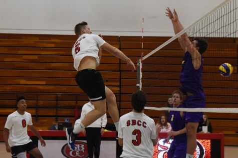 Vaquero sophomore middle-back Robert Gulvin (No. 5) spikes the ball past Cal Lutheran University defender Schaun Billing (No. 9) for a kill during the City College win on Wednesday, Feb. 3, in the Sports Pavilion. The Vaqueros won the season opener against the Kingsmen in four sets, 20-25, 25-21, 25-23 and 25-14.