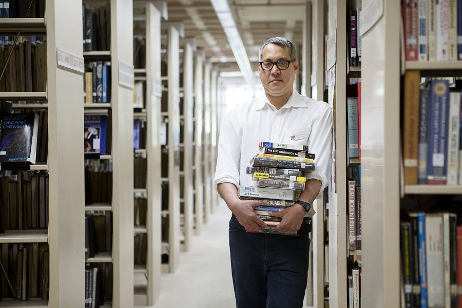 Library Technician Paul Fleischer holds a stack of his favorite books Thursday morning, April 21, at the Luria Library in Santa Barbara. Fleischers main duties at the library consist of helping students check out books, billing, and cataloguing. His favorite genre is the Beat Generation for its experimental and self-exploratory quality.