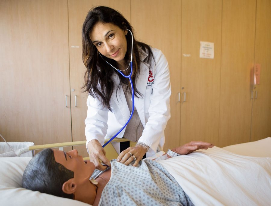 Nursing Instructor Rosette Strandberg uses a stethoscope one of the practice mannequin in the nursing lab on Tuesday morning, April 12, in the Health Technology Building room 277 at Santa Barbara City College. Strandberg also volunteers for Operation Smile, a nonprofit which offers surgical repair to children born with cleft palates.