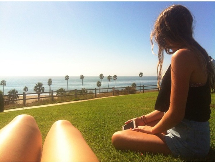 Student Megan Randolph sits on the West campus hill overlooking the ocean at Santa Barbara City College.