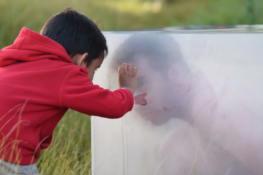 Alex Estrada, 4, tries to communicate with student artist Christian Garcia-Olivo, while he is performing his piece titled ‘Kindred Inherit’ on Sunday, May 1, outside the Humanities Building at Santa Barbara City College. The time-based art performances were part of the City College Annual Student Exhibition and this year was named ‘Outdoor Cat.’