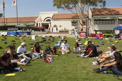 Miguel Cruz, president of the Still I Rise Writing Club (seated third from right), leads a discussion of depression and suicide during a writing circle on Tuesday, Sept. 20, during the “Send Silence Packing” event in front of the Luria Library. “I’m safe here; I feel loved,” said Cruz.