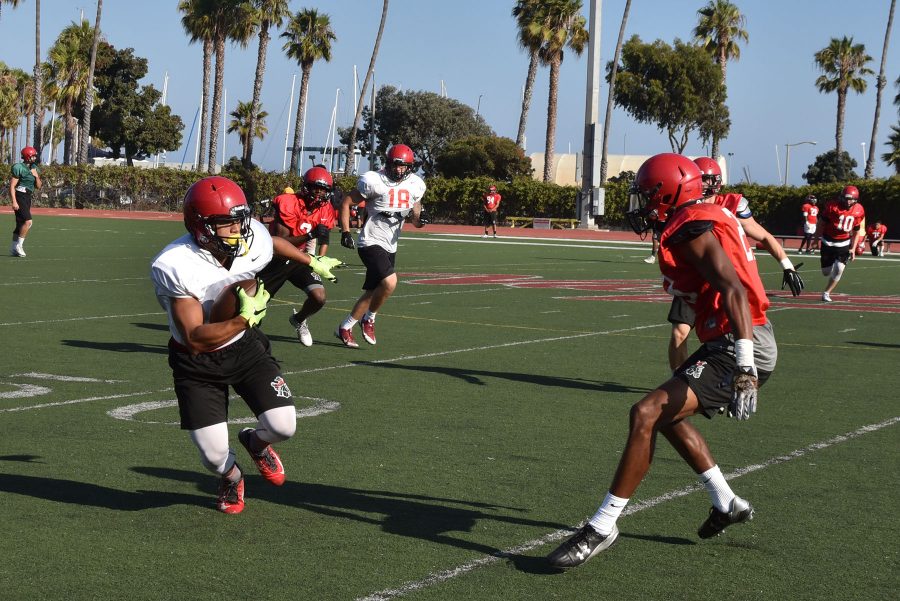 City College defensive back Rhomel Fields(right) prepares to tackle wide receiver Jason-Matthew Sharsh during practice on Monday, Aug. 29, at La Playa Field. The Vaqueros football regular season begins on Saturday, Sept. 3, in Ventura.