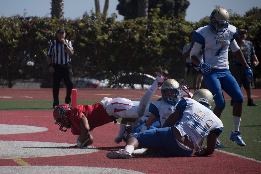 City College Wide Receiver Elijah Cunningham (no. 1) makes his way through four West Los Angeles defenders to put the Vaqueros up 35-21 in the third quarter during their home opener on Saturday, Sept. 10, at La Playa Stadium. The Vaqueros defeated the West Los Angeles College Wildcats 45-28.