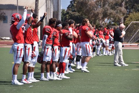 City College football players (From left) Elijah Cunningham (No. 1), Donald Lambert (No. 7) and Jonathan Licea (No. 6) stand in solidarity with NFL player Colin Kaepernick during the national anthem at the football game against South West Los Angeles on Saturday, Sept. 17, at La Playa Stadium. of African Americans.
