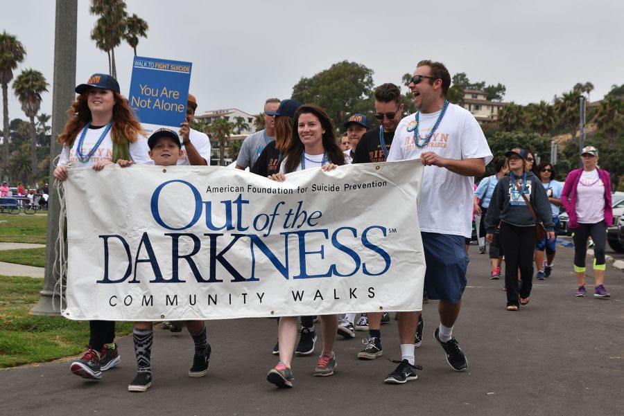 The suicide prevention banner is carried by (from left) Polly Davidson, Makai Callis, Brooke Cuevas and Orion Brutoco during the community walk on Sunday, Sept. 11, on Leadbetter Beach in Santa Barbara. The four were walking in remembrance of Ripkyn Strader, a previous City College student, who passed away on Aug. 16, 2016 from suicide.