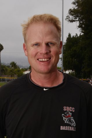 Jeff Walker stands on the baseball field on Wednesday, Sept. 7, at Pershing Park. Walker was recently hired as a full time faculty member.