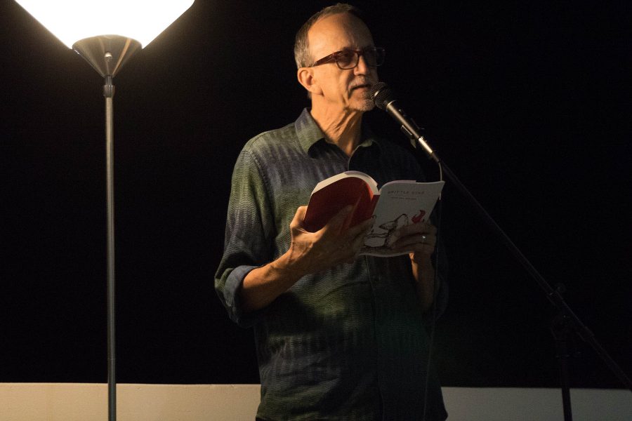 Rod Val Moore, author and member of What Books Press, reads an excerpt from his novel “Brittle Star” at a collective reading performance on Thursday, Oct. 20, on the balcony of the Atkinson Gallery. City Colleges creative writing department and Gunpowder Press sponsored the reading.