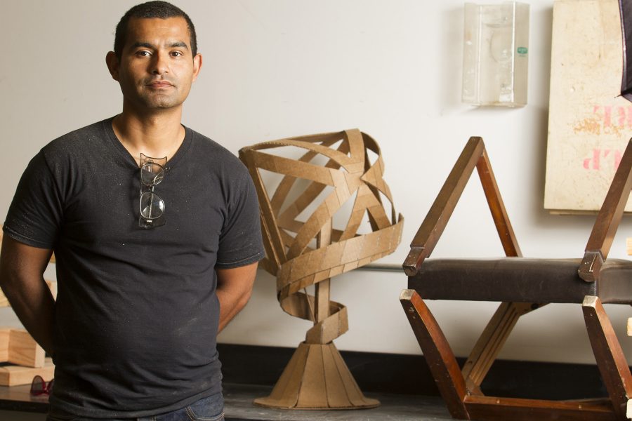 Armando Ramos stands with student sculptures on Monday, Oct. 3, in his lab in the Humanities Building at City College. Ramos is the new arts instructor who specializes in 3D sculptures made from all different types of material, such as wood and cardboard.