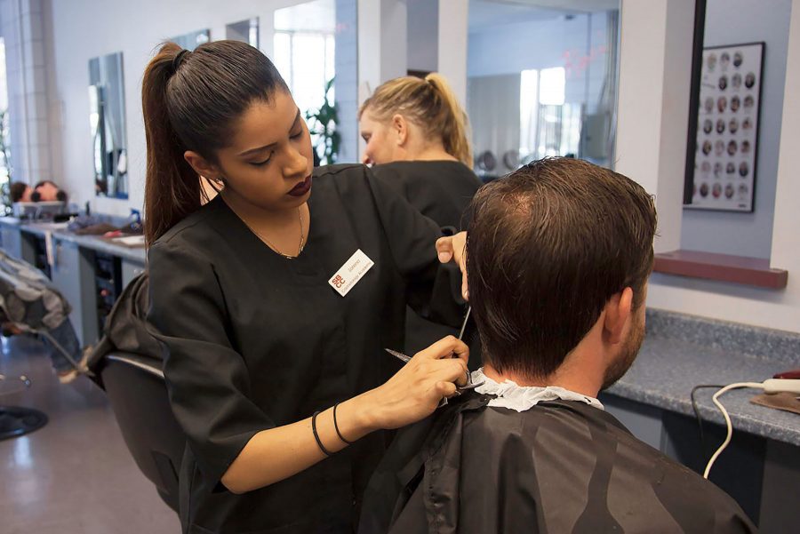 Lorena Almanza cuts a clients hair for $5 to raise money for the Surf Rider Foundation on Sunday, Oct. 2, at City College’s Cosmetology Academy in Goleta. All proceeds went to the foundation to help protect the communities’ coastal environment.