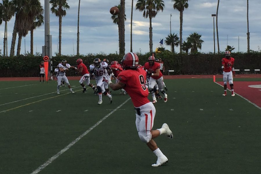 Joseph Osegueda (No. 14), Vaquero fourth string quarterback, completes a pass to running back Cedric Cooper (No. 9) for a 15-yard gain during the second quarter on Saturday, Oct. 29, at La Playa Stadium. City College defeated Citrus College, 46-44, in double overtime.