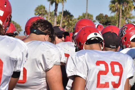 Craig Moropoulos (center), City College head football coach, discuses tactics with the offence on Monday, Aug. 29, at La Playa Stadium. This is Moropoulos’ 10th year as the head football coach and has led the team to a 5-2 record so far this season.
