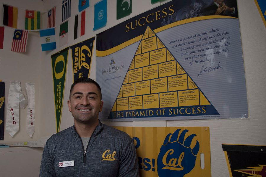Andrew Gill's office walls are covered with university banners and small foreign country flags on Thursday, Oct. 13, at City College. Gill was recently hired as a second full-time counselor for the Express to Success Program.