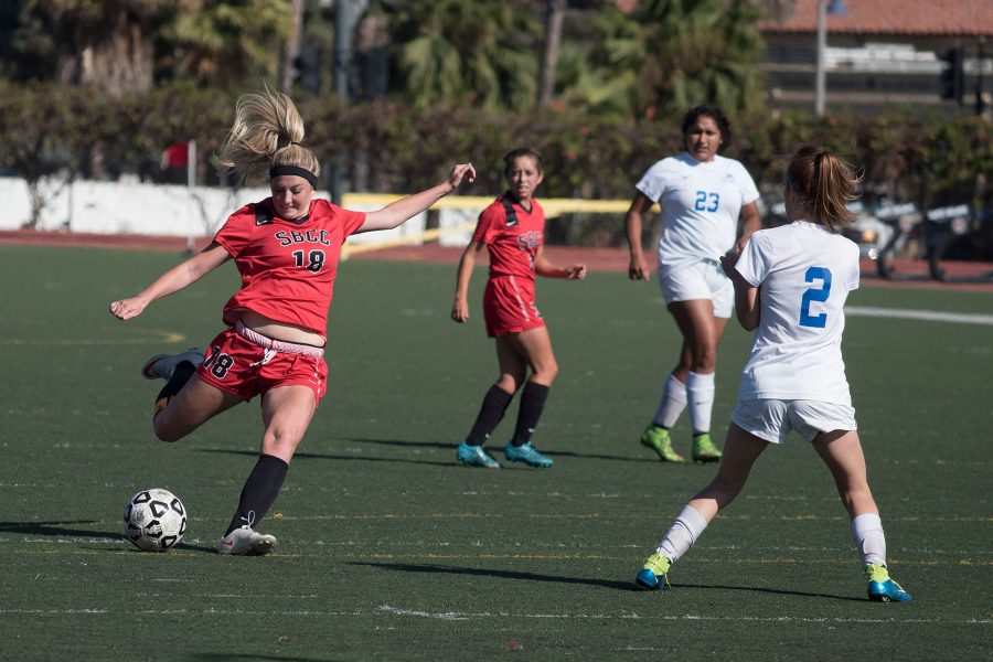 Vaquero forward Kathryn Sullivan (No. 18) kicks the ball past Bulldog defender Lacei Sanders (No. 2) to score the fourth goal on Tuesday, Oct. 11, at La Playa Stadium. City College shut out Allan Hancock, 5-0, in their Western State Division opener.
