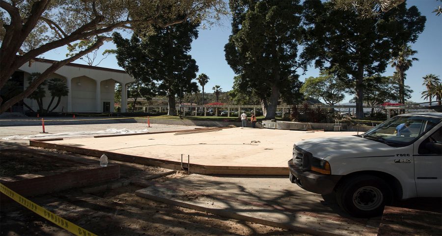 Workers construct the base for the new tent structure that will temporarily replace the cafeteria, Thursday, Oct. 20, next to the Student Services Building in the Student Services Courtyard. The Campus Center, which houses the cafeteria, will be demolished at the end of the spring semester.