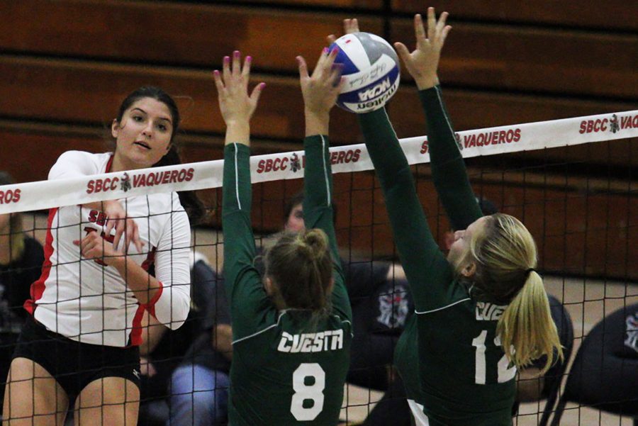 Vaquero Outside Hitter Carolyn Andrulis (No. 15) spikes the ball against Cougars Kelly Cole (No. 8) and Morgan Lawson (No. 12) on Wednesday, Nov. 2, in the Sports Pavilion. City College conquered Cuesta College 3-0.