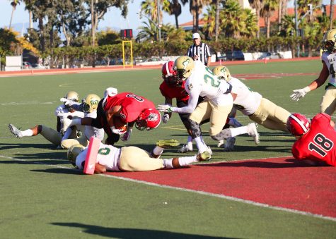 Sophomore Cedric Cooper (No.9) jumps over a heap of defenders in the third quarter for a touchdown against LA Valley on Nov. 12, at City College’s La Playa Stadium. City College lost to LA Valley, 47-35.