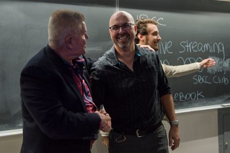 Philosophy Instructor Mark McIntire (left) shakes hands with Biological Sciences Associate Professor Adam Green after their debate about climate change put on by 2020 A Year Without War on Wednesday, Nov. 16, at City College. The two agreed on several points regarding climate change but differed on how to fix the problem.