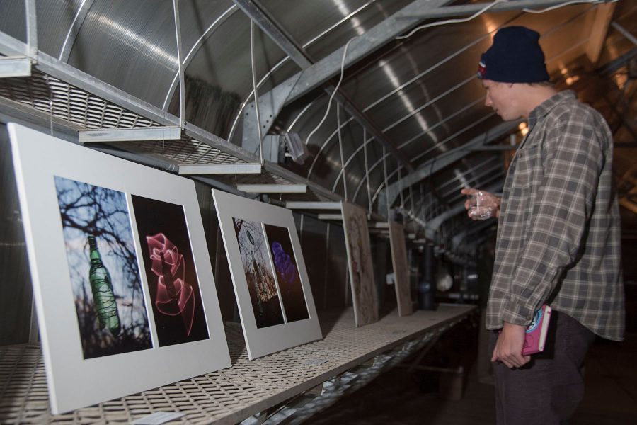 English major Cole Waldron walks through the exhibition looking at all the student works of art on Tuesday, Nov. 29, City College East Campus green house. The student art exhibition was called Garden Observations and had various student art works on display.