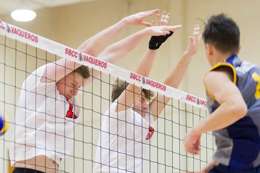 City College Vaqueros Sean Reynaert (No. 11) and Jarrod Jordan (No. 5) attempt to block an attack by the Fullerton College Hornets on Saturday, Jan. 28, in the Sports Pavilion. The Hornets won the game, 3-2.