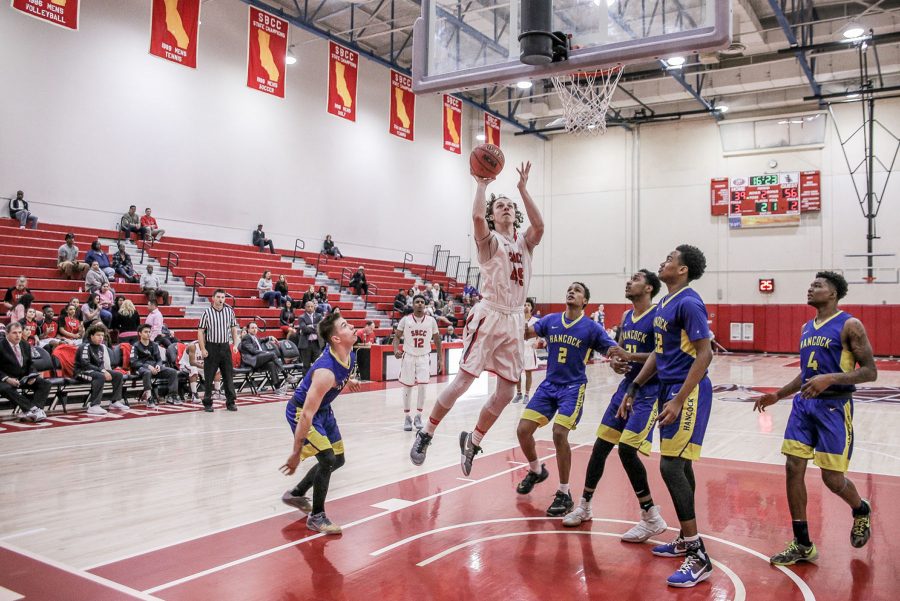 Vaquero Robert Livingston (No. 45) scores in the middle of five Hancock Bulldogs on Saturday, Feb. 11, in the sports pavilion at Santa Barbara City College. The Vaqueros lost 96-85. The proceeds from the game are going to the American Cancer Society.