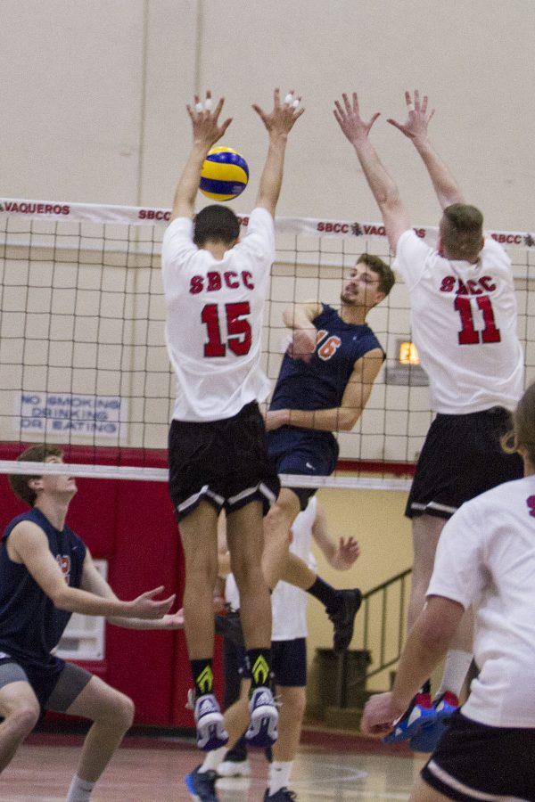 City College Vaqueros, Jarret Futch (No. 15) and Sean Reynaert (No.11) attempt to block a kill by Orange Coast College Pirate, Jordan Hoppe (No.16) on Wednesday, Feb. 8, 2017, in the sports pavilion at Santa Barbara City College. According to Futch, the Vaqueros have not beaten the Pirates in a set in four or five years.