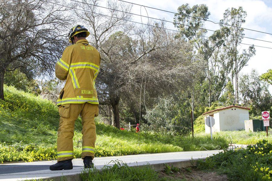 A Santa Barbara City Fireman on Loma Alta Drive after the power line snapped causing City College and neighboring areas to lose power Wednesday, March 22, at City College. The Bridge between East and West Campus was closed after a small fire from the downed power lines.