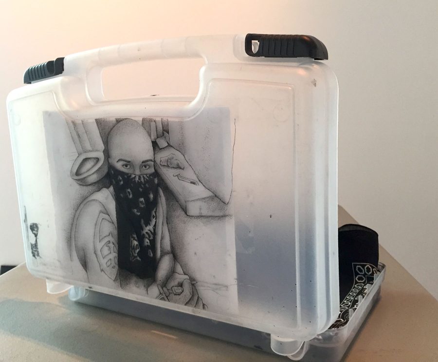 Courtesy art of the Student Art Exhibition. Alberto Lule, Self-Portrait in Prison, Tattooed ink on art kit