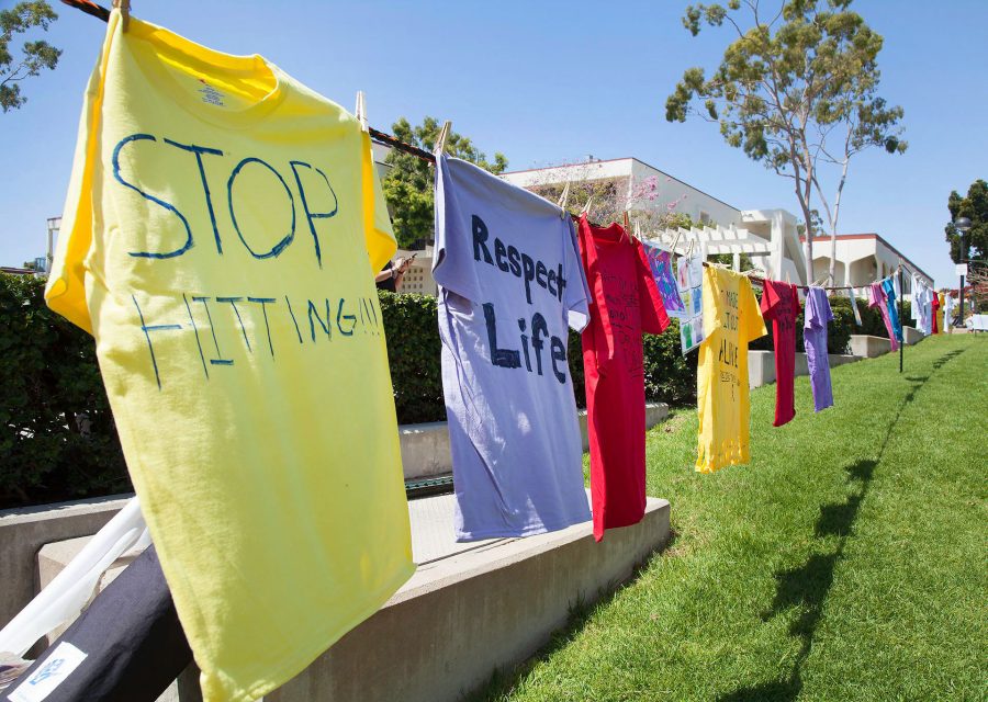 Different colored shirts that students have written on for the Clothesline Project on April 12, at the Friendship Plaza at City College. At the event, students made different colored shirts to tell their story. A red shirt symbolizes rape, a yellow shirt symbolizes domestic violence, and a purple shirt stands for physical or sexual abuse against the LGBT+ community.