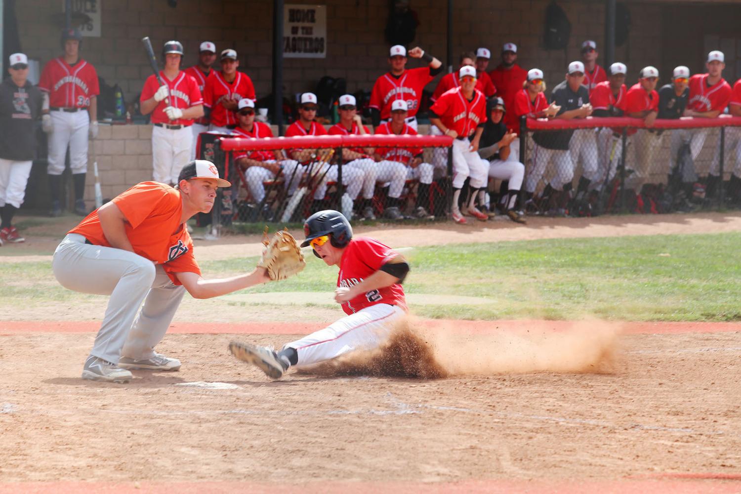 Freshman Reinhard Lautz (No. 2) slides into home base in the fifth inning and makes the run after Sophomore Tyler Rosen (No.11) hits the ball against Ventura College on Tuesday, April 25, 2017 at Pershing Park. The Vaqueros won 6-5.