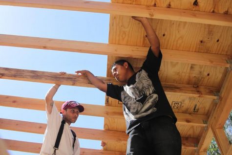First-year construction students Nathan McBrayer and Jonathan Pena hold onto the wood panels inside the tiny house on Saturday, April 29, at Wake Campus. By the end of the semester, students will have finished the frame, roof and walls of the tiny house.